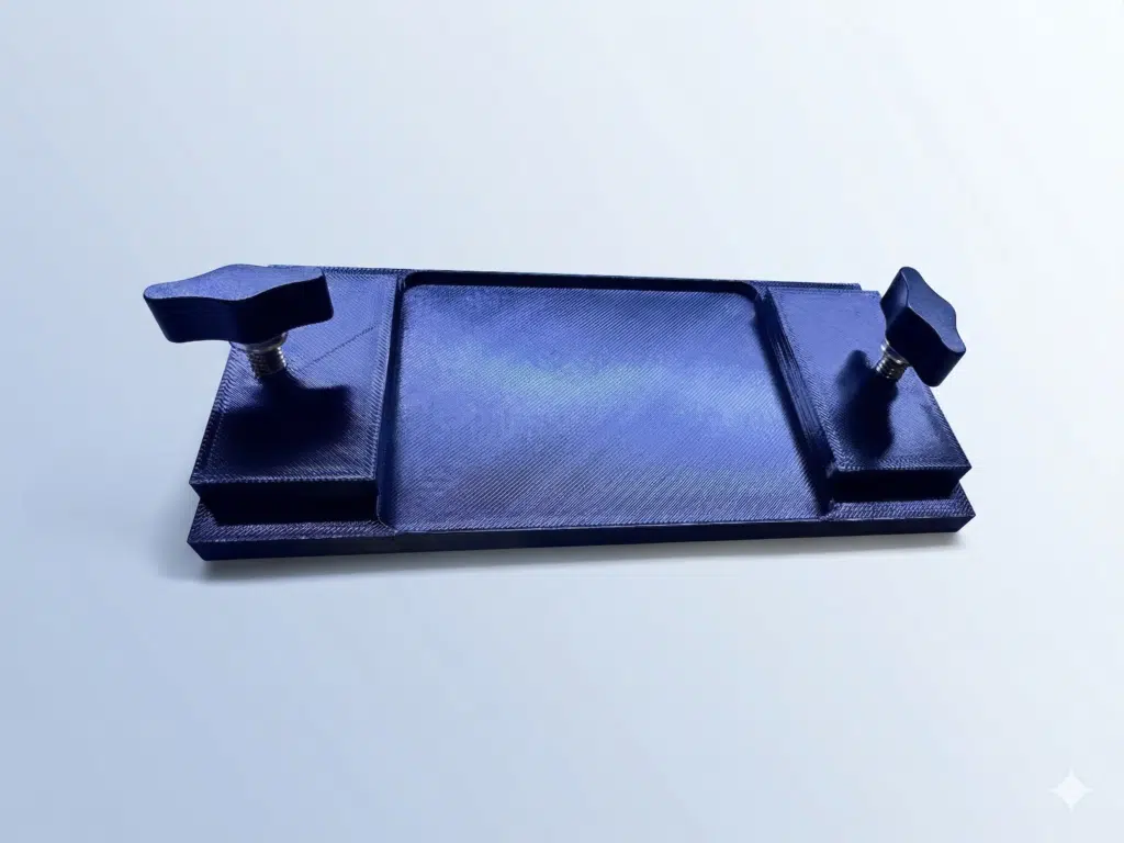 The TraxTech 6" Track Adapter Plate for Universal Transducer Pole Mount is a blue rectangular plastic device featuring a central tray and two adjustable knobs, displayed against a light gradient background.