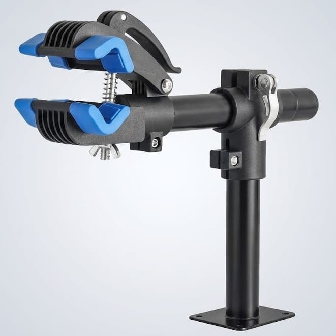 A black and blue adjustable bike repair stand clamp with a sturdy base, spring mechanism, and padded jaws for holding a bicycle frame securely.