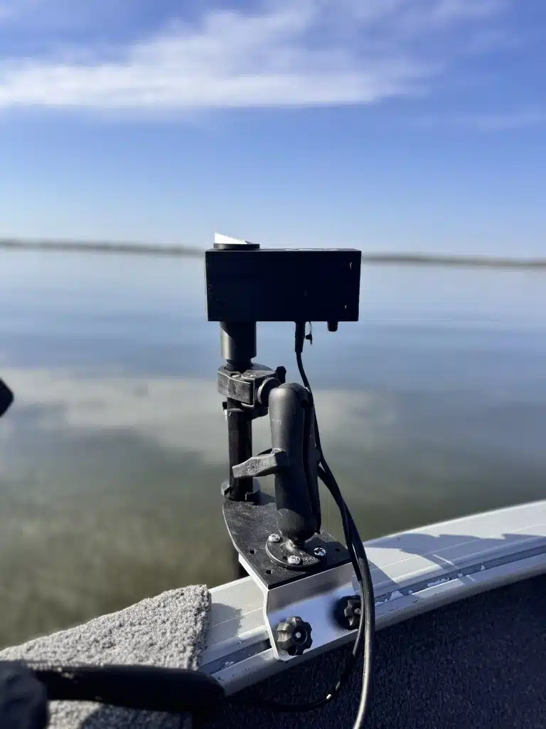 XT power head clamped to a boat gunnel over clear water