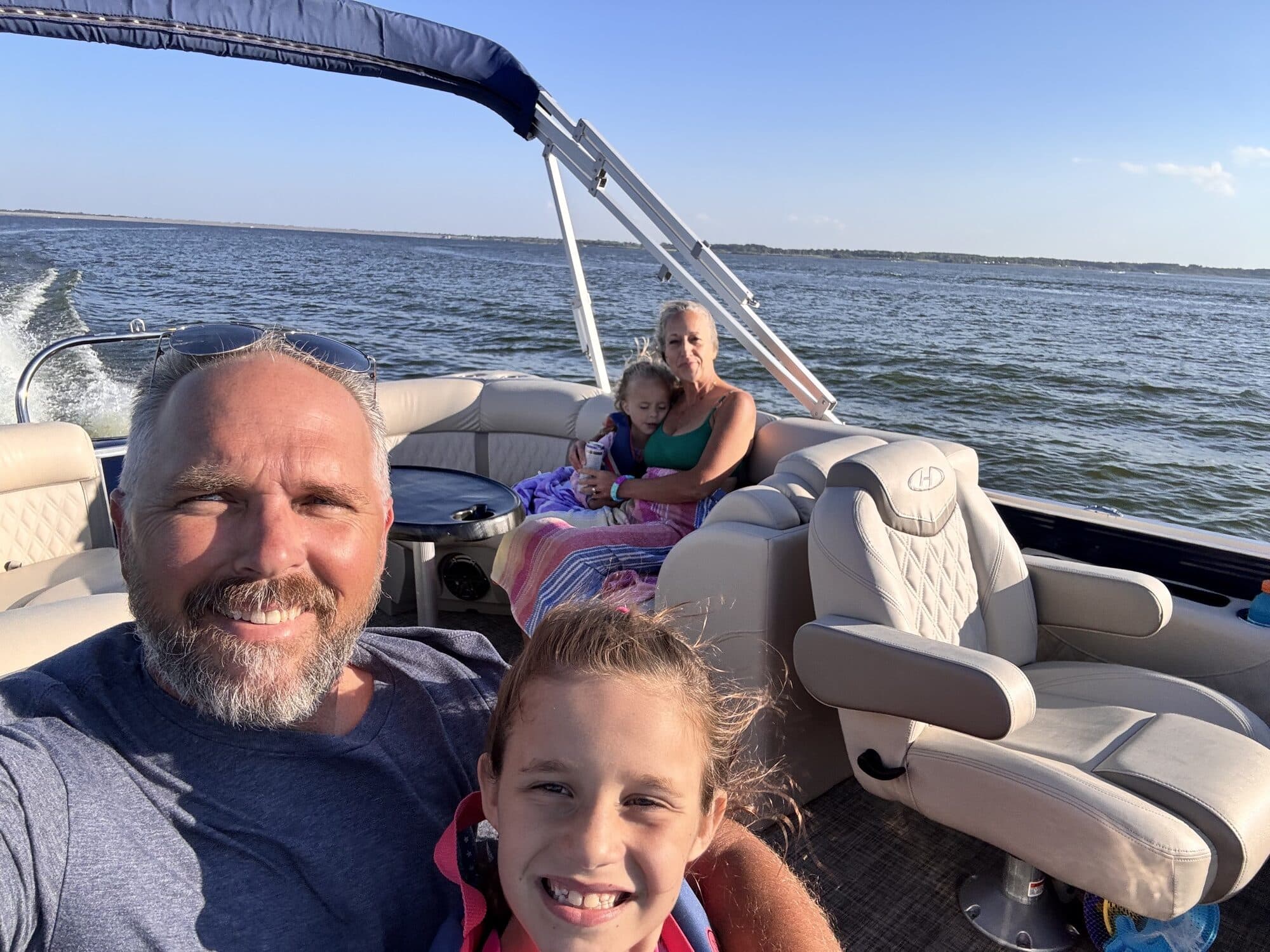 Family evening ride on a pontoon boat with the founder at the helm